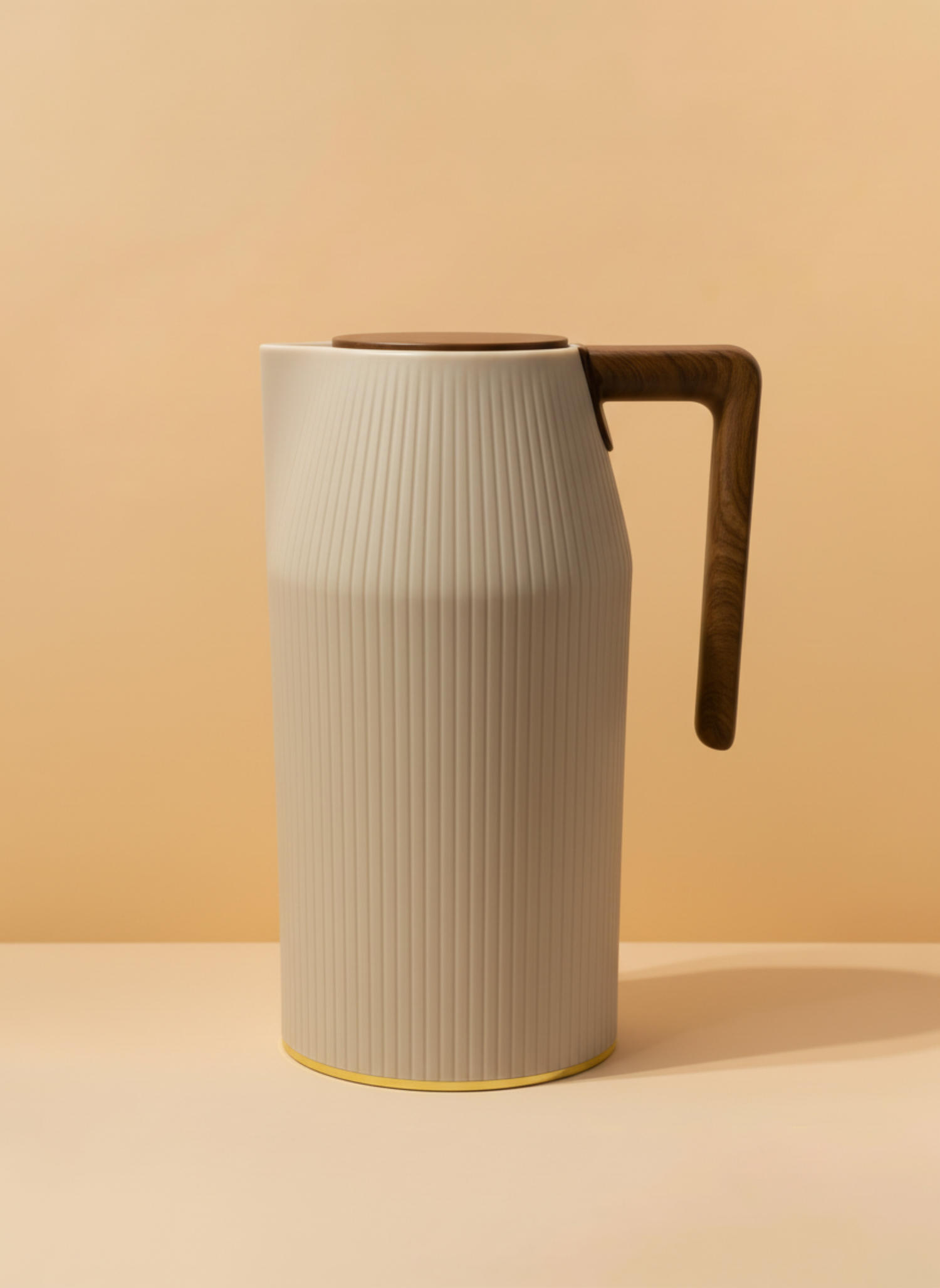 Beige ceramic pitcher with wooden handle on a beige background